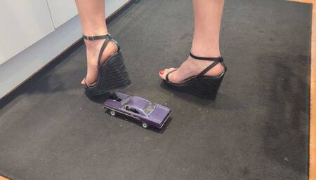 Giantess Raven Lee crushes a 1970 Plymouth GTX toy car in sexy black wedges with painted toenails high right view