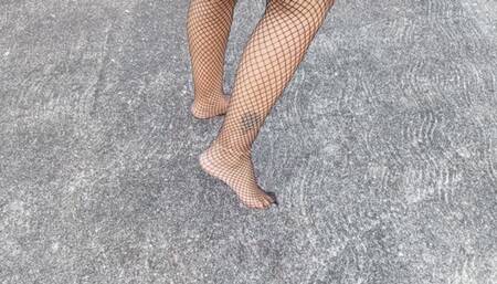 Beautiful lady with pronounced arches walks barefoot and wearing fishnet stockings (3)