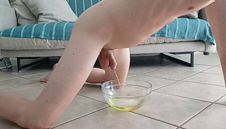Doggy-style naked boy pees in a bowl