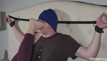 Foot slave is bound to the headboard and gagged mercilessly