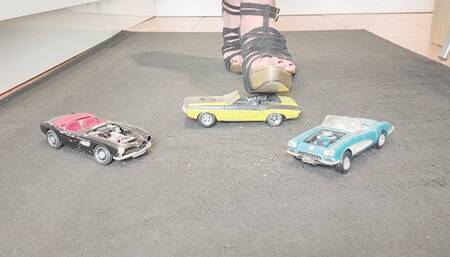 Giantess Raven Lee crushes a 3 classic American convertible toy cars in sexy heels with painted toenails close up ground view
