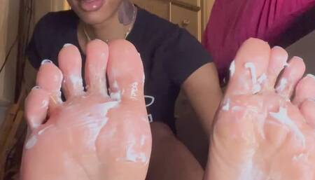 Goddess Yemayá oiling and lotioning pretty soft pink size 13 soles rubbing and massaging her pretty feet blueberry toes for her pleasure