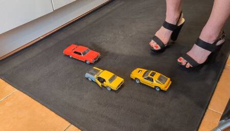 Giantess Raven Lee crushes uses 3 cars as stepping stones in big black chunky heels with painted toenails high right view