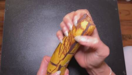 Long sharp natural nails destroying banana