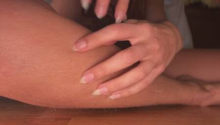 Natural nails scratching hairy legs