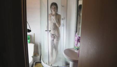 Lustful brunette fondles her holes in the shower