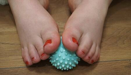 Playing with toes with a massage ball