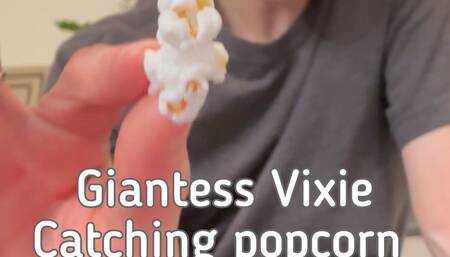 Giantess Vixie catching popcorn in her giant mouth with Tiny Man inside