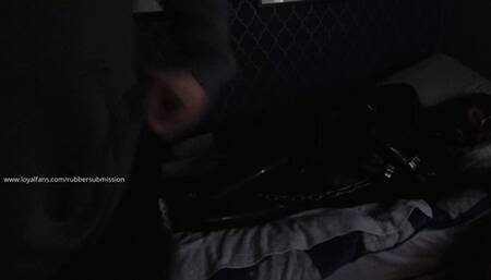 Black Rubber Drone Restrained On The Bed