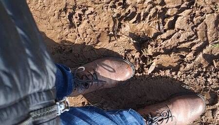 RUBBING BOOTS IN THE MUD AND GRASS