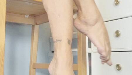 bare legs crossing in wooden chair