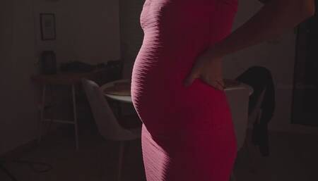 Very bloated in a pink dress