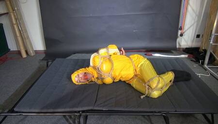 Ms Ungeniert bound and gagged in a shiny nylon Rainsuit trying to get free