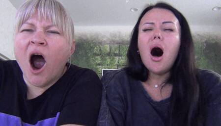 Blonde and brunette yawn widely b