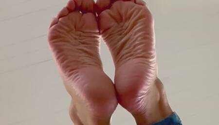 Crossed, wrinkled sole scrunches and toe wiggles