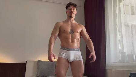 FlexMan the oiled up superhero is made to cum on camera