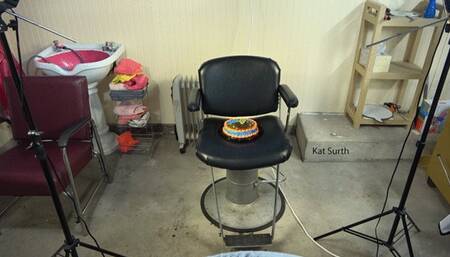 Womancake sitting and getting messy in black vinyl pants and shirt and tie