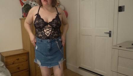 Dancing striptease in denim miniskirt and black lace top