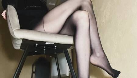 Sexy feet in black nylon pantyhose