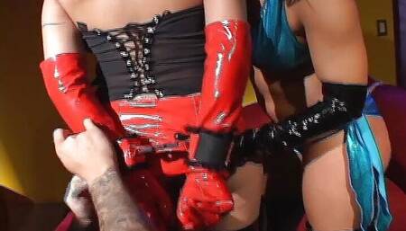 Two Latex Dominas Take Each Other Hard in Their Holes