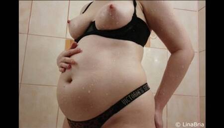 Chubby girl plays with her grown tummy, boobs and masturbates in the bathroom