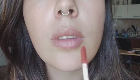 Kissing and appliying lipglosses close-up