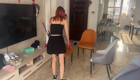 The girl in sneakers rearranges and cleans up, but her slippery sole on her sneakers does not allow her to move the furniture