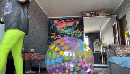 Girl in leggings riding on intex dotted beachball