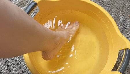 A young woman makes foot baths