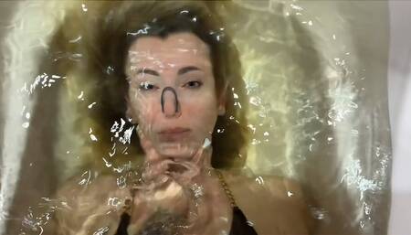 Girl holds Helga underwater and plays with her hair