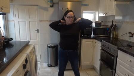 in the kitchen undressing in jeans and black top
