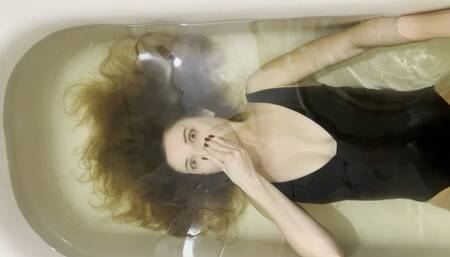 Milana training her breath in the bathtub