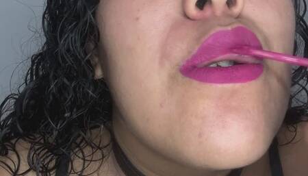 Sensual, fleshy lips playing with a lollipop