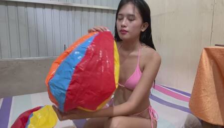 Savannah blowing and riding beach ball