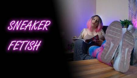 Lady Angela is relaxing with a magazine while you stare at her dirty sneaker bottoms