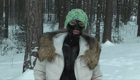 Girl in black rubber latex catsuit enjoys the snow landscape