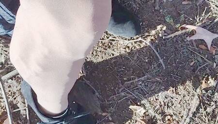 In black bootie wedges and pantyhose