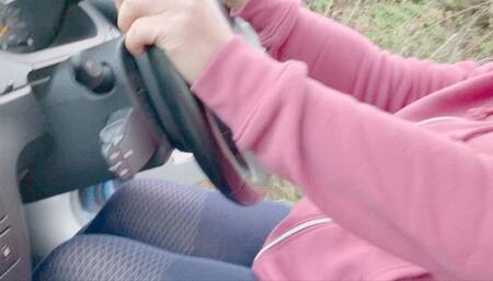 Pumping pedals in a car with bare feet in gray tights