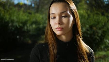Beautiful Yulia is smoking brown cigarette