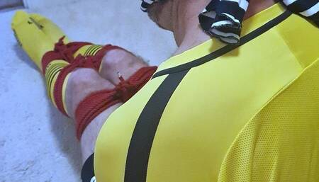 Footballer in yellow and black kit struggling to get out of tight bondage
