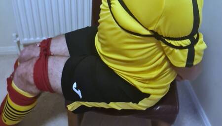 Footballer in yellow and black kit struggling to get out of tight bondage 3