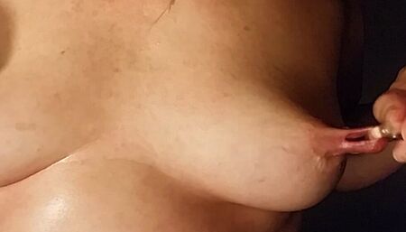 Nippleringlover horny milf inserting multiple rings in extreme stretched pierced nipples and rubbing pierced pussy