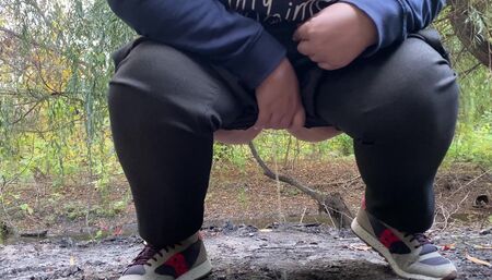 MILF dressed in pants pissing in public outdoors